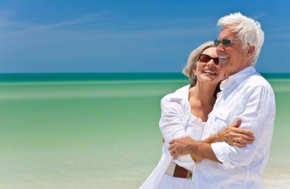 Happy Senior Couple Looking To Sea on A Tropical Beach